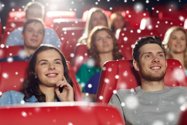 Cinema Entertainment And People Concept Happy Friends Watching Movie In Theater With Snowflakes