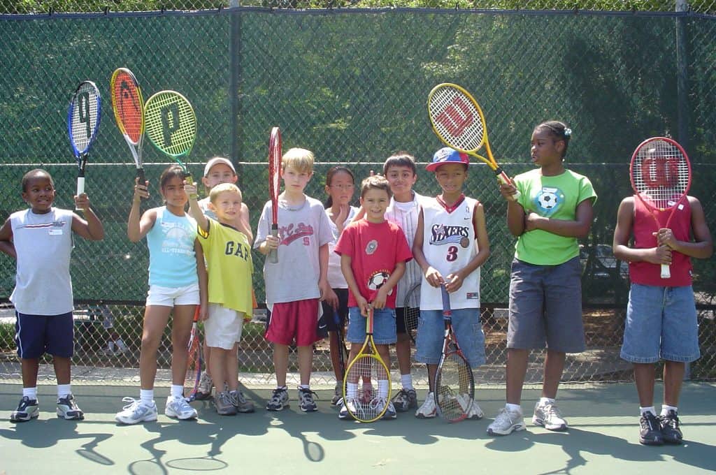 kids with tennis racquets getting ready for free tennis lesson in Raleigh