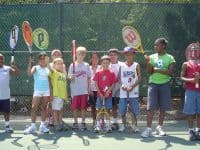 kids with tennis racquets getting ready for free tennis lesson in Raleigh