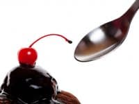 A Chocolate Covered Sundae With A Red Cherry Ready To Eat Shot On White Background