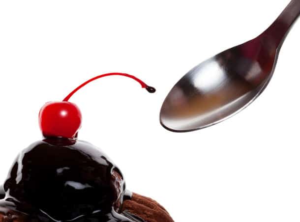 A Chocolate Covered Sundae With A Red Cherry Ready To Eat Shot On White Background