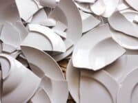 many broken white plates on the floor