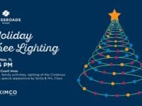 banner for holiday tree lighting at Crossroads Plaza