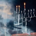 silver colored menorah with three candle