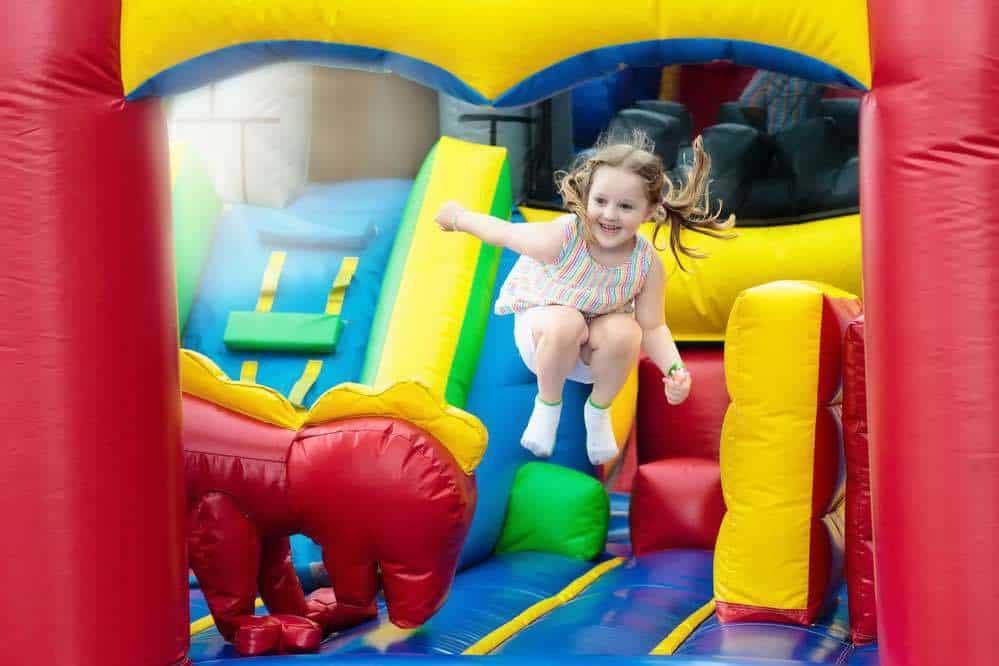 Child playing on colorful inflatable playground