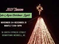 Top of illuminated christmas tree, with star. words: 2021 season, Nov 24-Dec 31, 5:30 to 10 p.m. 10 south cypress street, wendell