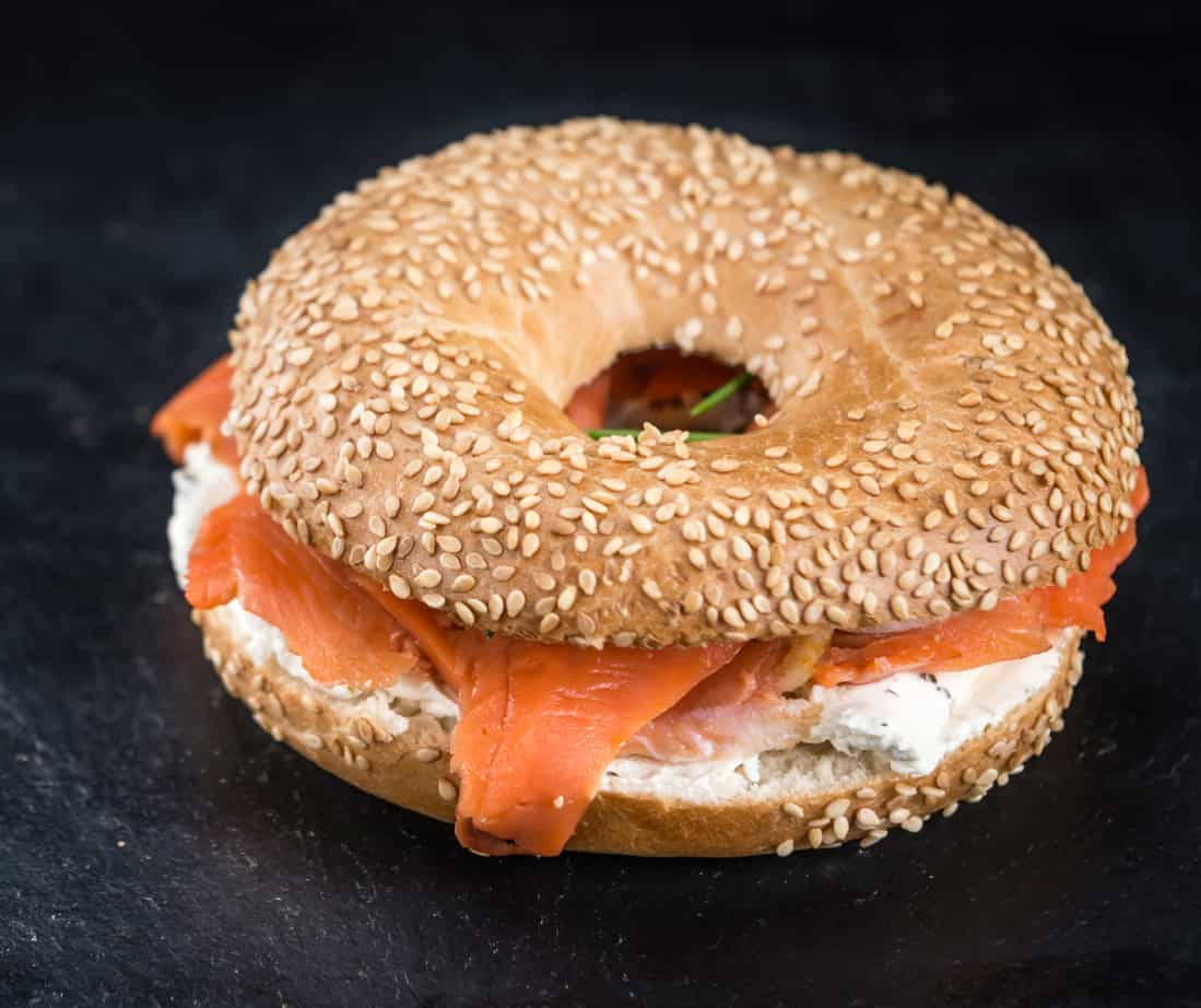 sesame seed bagel with cream cheese and smoked salmon