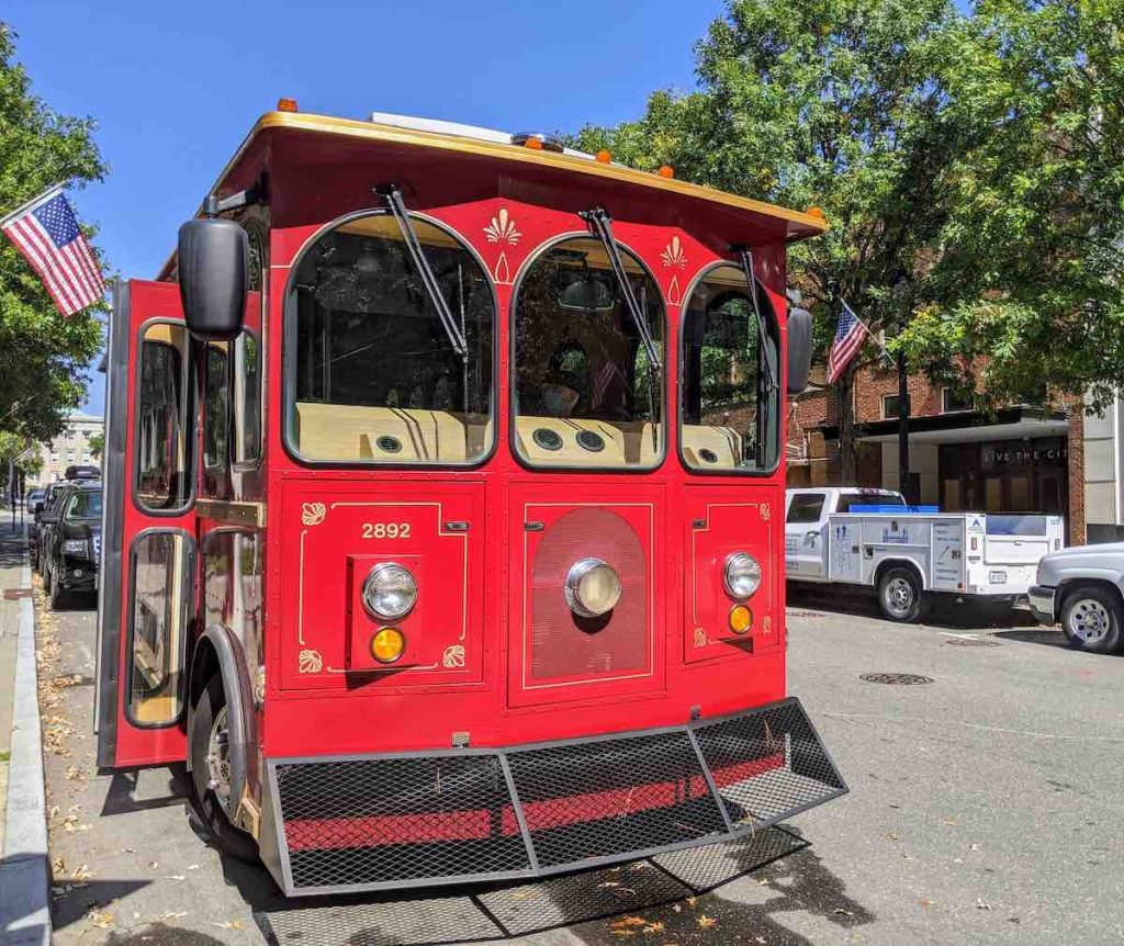 Front view of bright red historic trolley in Raleigh, NC