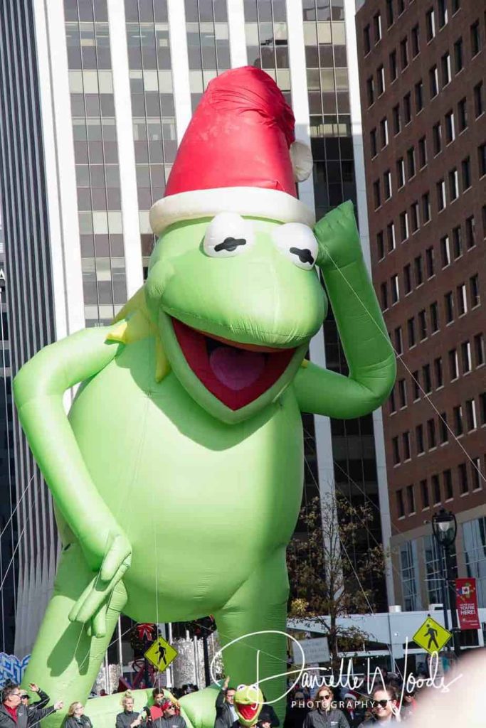 Large kermit the frog balloon in parade
