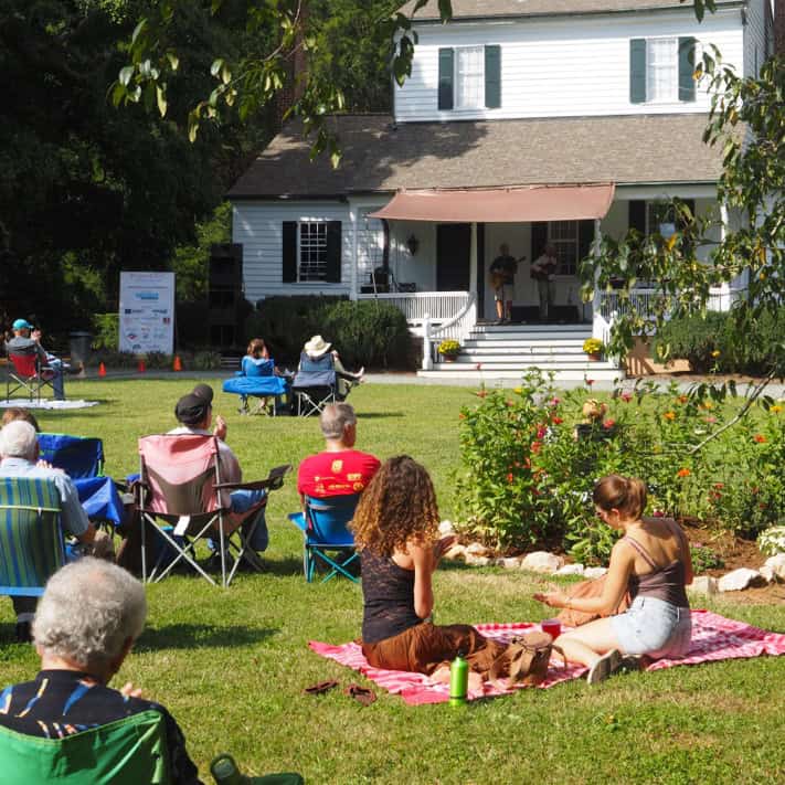 People on lawn listening to music
