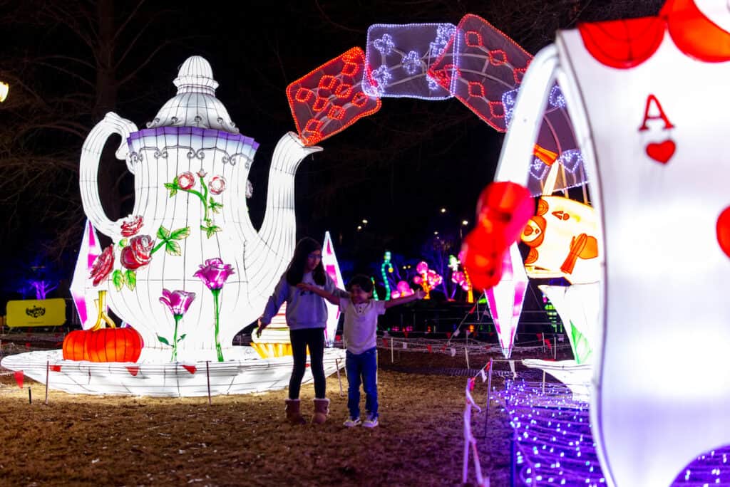 Large illuminated lanterns depicting teapots and playing cards at LuminoCity Festival at Pullen Park, Raleigh, NC