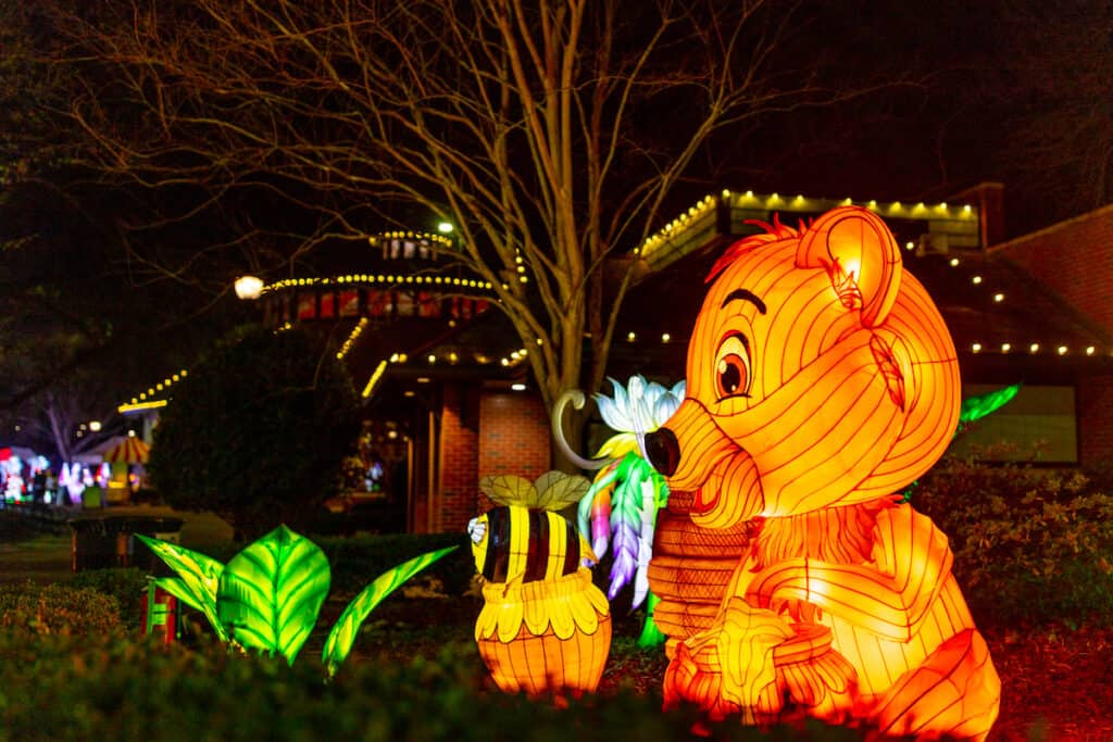 Large illuminated lanterns depicting a bear and a bee at LuminoCity Festival at Pullen Park, Raleigh, NC