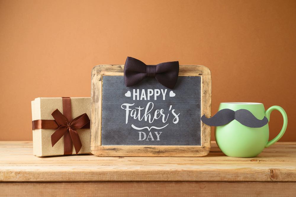 father's day message on small blackboard with mug and gift