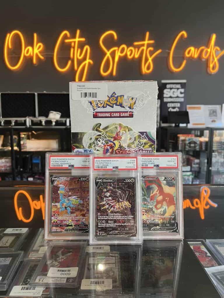 Pokemon trading card game in front of Oak City Sports Cards neon sign
