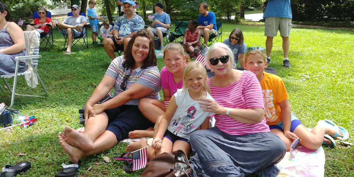 families relaxing on lawn of Horace Williams House in Chapel Hill, for 4th of July celebration