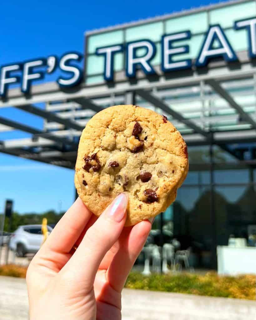 chocolate chip cookie held outside Tiff's Treats