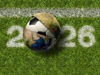 Soccer ball emerging from globe