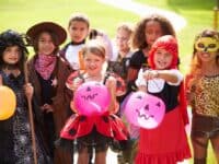 children in Halloween costumes trick or treating