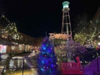 American Tobacco Campus in Durham, lit up for the holidays, with view of water tower