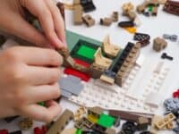 Child putting together Lego set, close-up