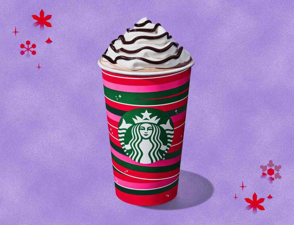 Starbucks cup with hot chocolate and whipped cream