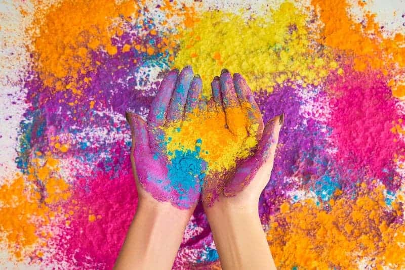 Hands holding colored powder for Holi