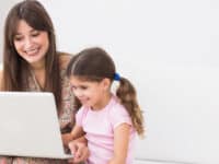 Mother and daughter looking at laptop