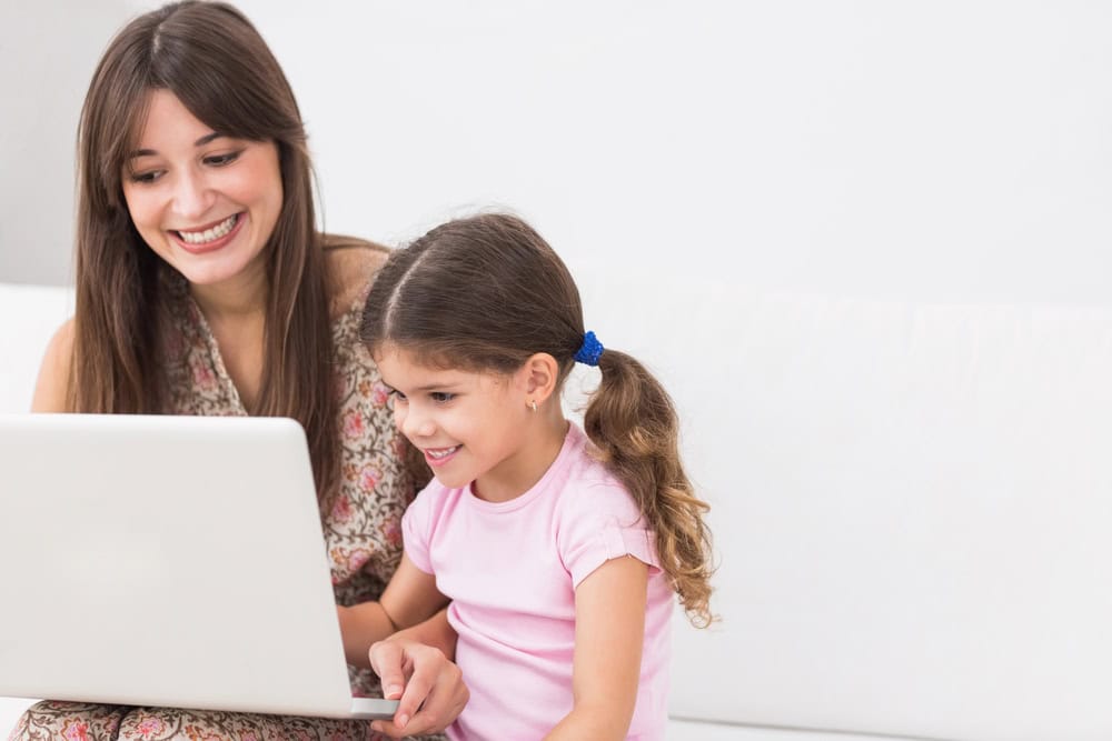 Mother and daughter looking at laptop