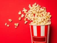 popcorn in bucket with red background