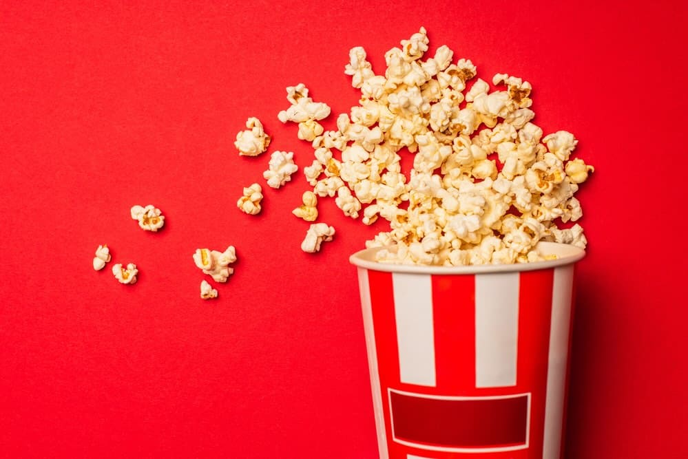 popcorn in bucket with red background