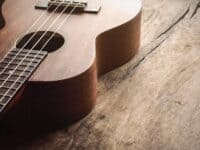 Close up of ukulele on old wood background with soft light