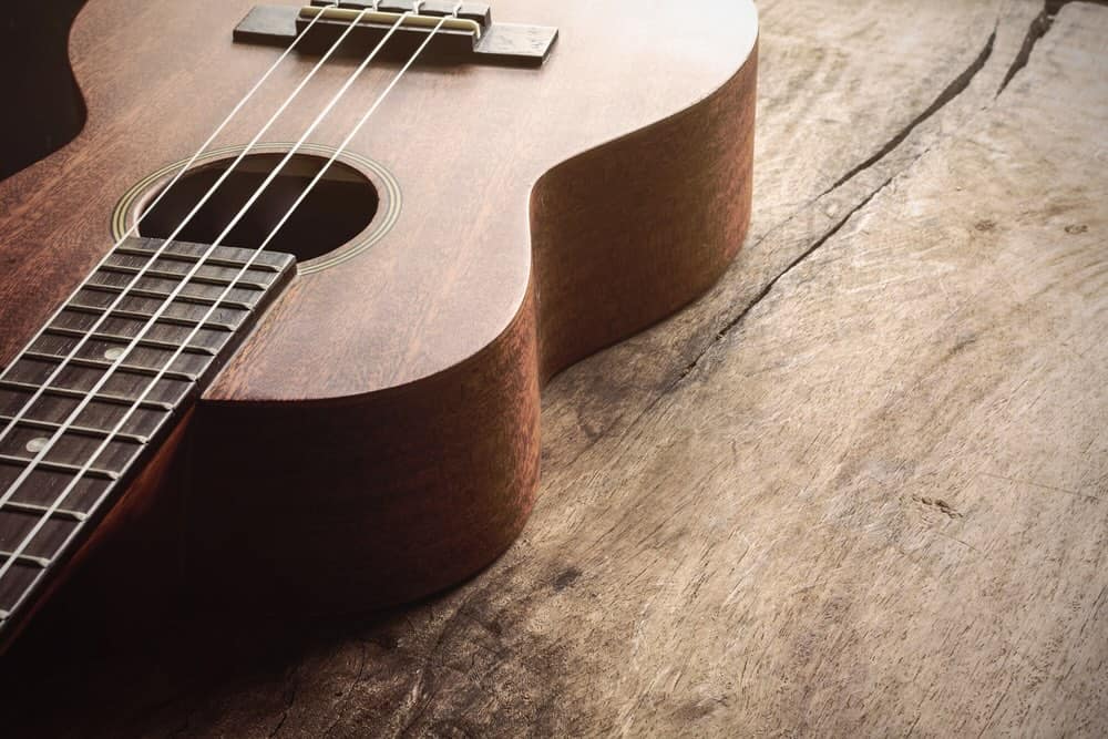 Close up of ukulele on old wood background with soft light