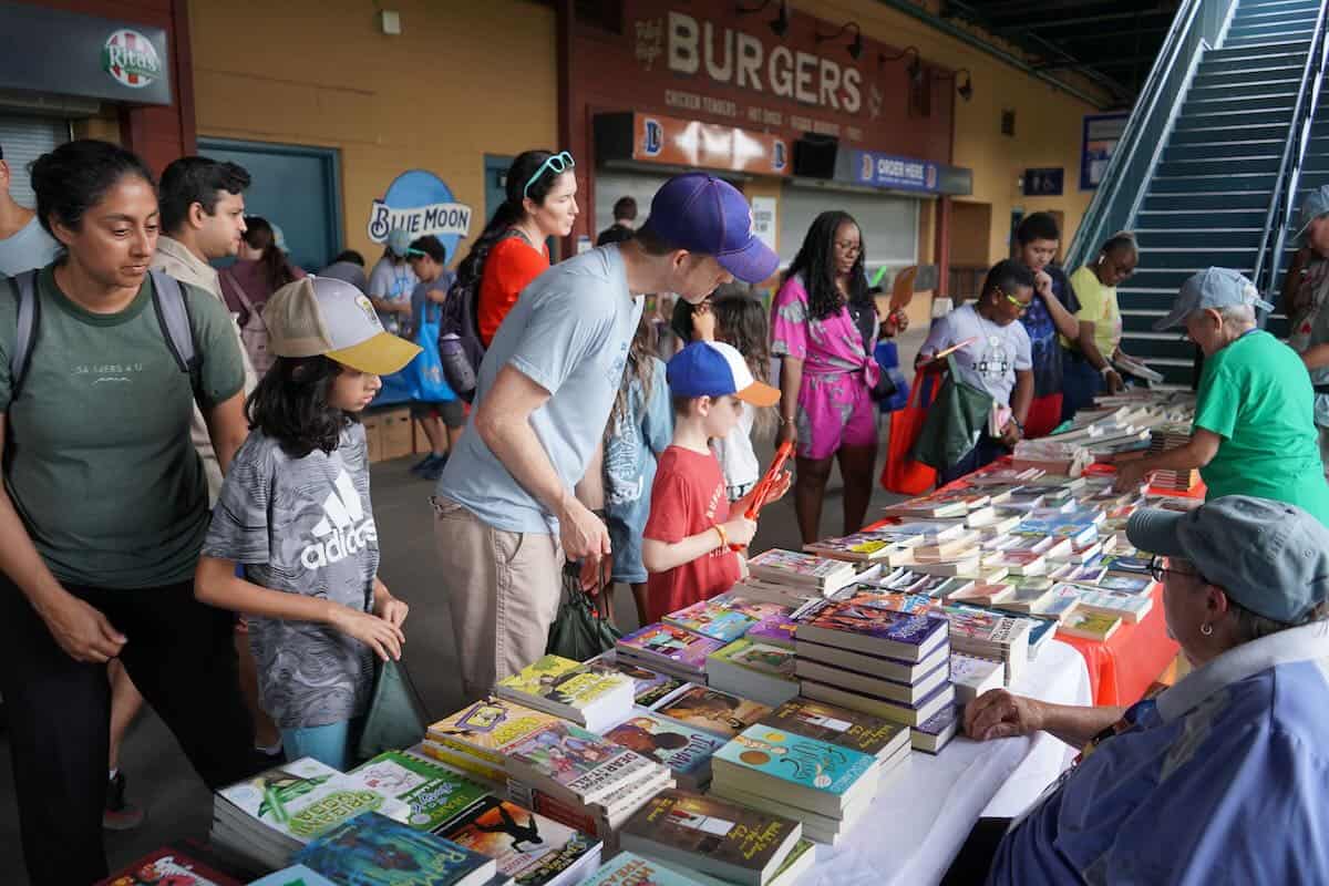 families looking at books on table