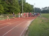 A group of people on a track running together