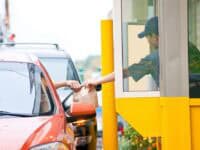 customer receiving bag of food at drive-thru window
