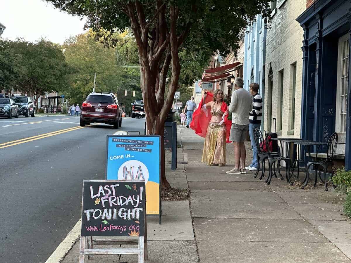 Belly dancer and other people on sidewalk during Hillsborough's Last Fridays Art Walk