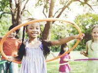kids playing with hula hoops outside