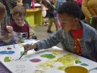 children painting at a table