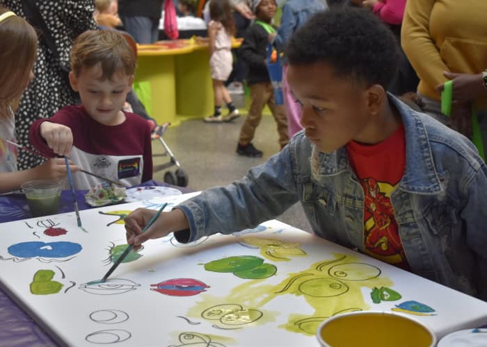 children painting at a table