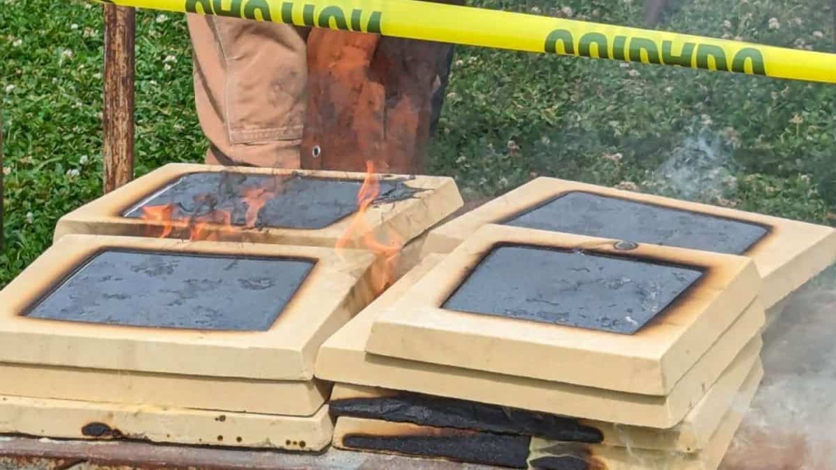 Man pouring iron into tiles
