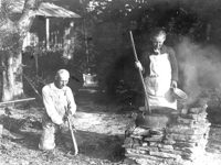 black and white photo of two people working outside