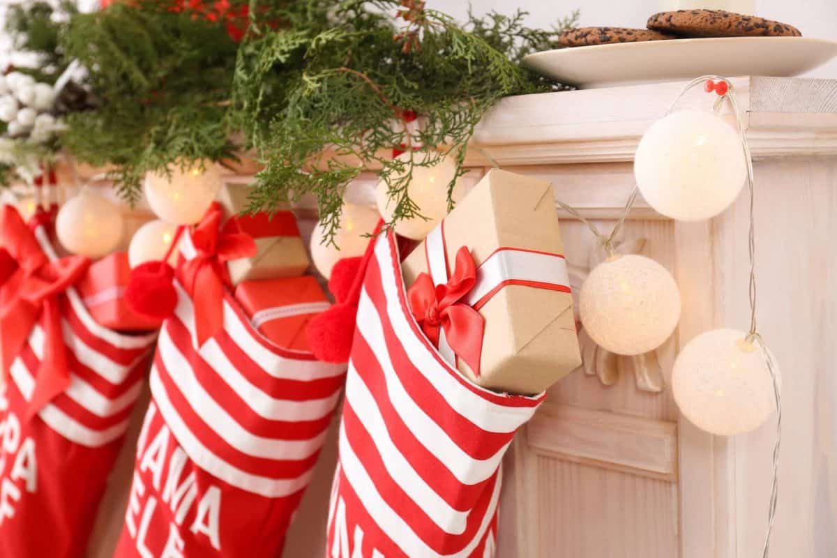 red and white stockings hanging on mantel