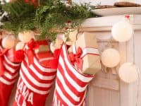 red and white stockings hanging on mantel