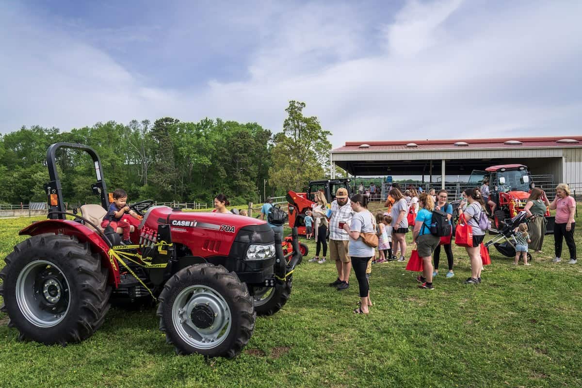 Child on a tractor in a field