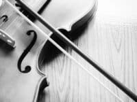 stock image of fiddle/violin on table, with bow. Close-up. monochromatic picture