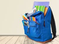 Blue backpack filled with school supplies