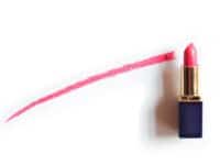 Red lipstick near painted line on white background