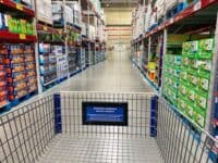 Interior of sam's Club, from behind a shopping cart on an aisle