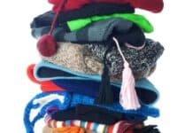 Small stack of woolen winter hats. Isolated on white background